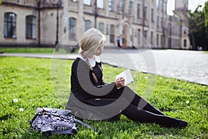 Blond student girl in schoolyard