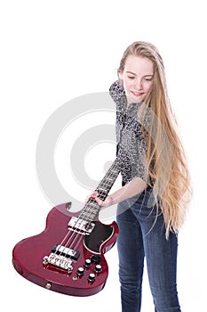 Blond teen girl and bass guitar against white background in stud