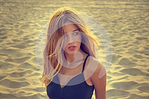 Blond teen girl portrait on the beach sand