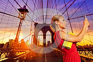 Blond tourist girl selfie photo in Brooklyn Bridge