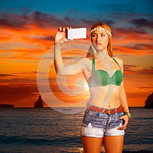 Blond tourist girl taking selfie photo Benirras Ibiza