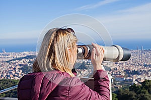 Blond woman admiring Barcelona from the top of Tibidabo