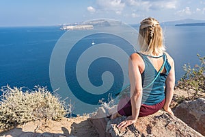 Blond woman admiring landscape of Santorini caldera