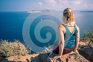 Blond woman admiring landscape of Santorini caldera