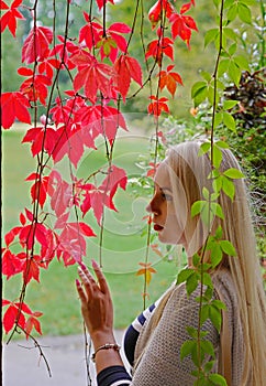 Blond woman and autumn foliage. Autumn concept.