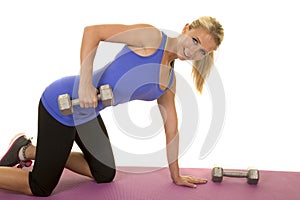 Blond woman blue fitness tank kneel lift weight look