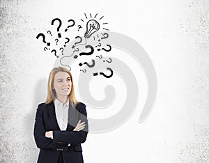 Blond woman with crossed arms and light bulb with question marks