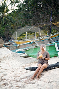 Blond Woman Drink Coconut Water on Wooden Boat