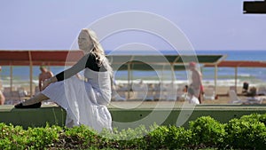 Blond woman enjoying sea view.