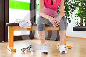 Blond woman exhausted, resting after gym workout