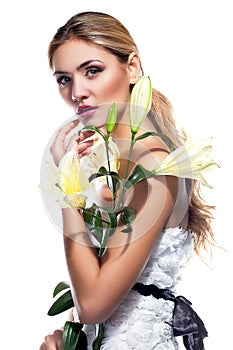 Blond woman with fresh clean skin and white lily flower isolated