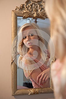 Blond Woman Gazing at Self in Mirror