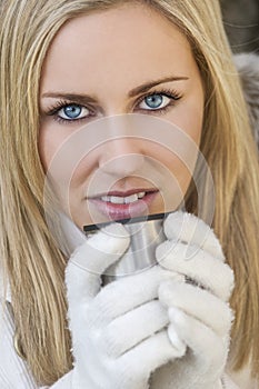 Blond Woman In Gloves Drinking Warm Drink