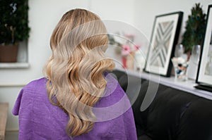 Blond woman with hairstyle of long wavy hair
