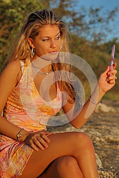 Blond woman with hand mirror