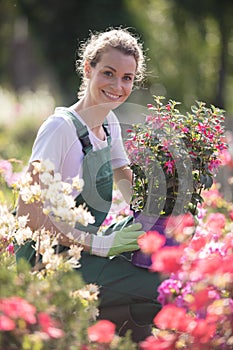 blond woman with hat gardening