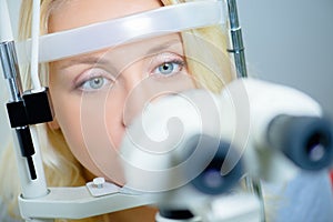 Blond woman having eyes tested