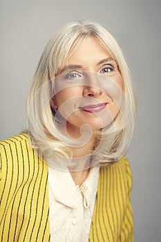 blond woman in her 50s posing