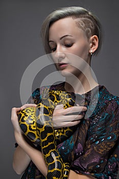 Blond woman holding snake