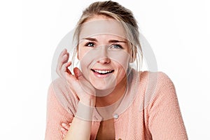 Blond woman laughing using hands for care and softness