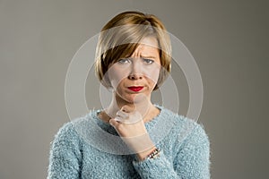 Blond woman looking suspicious and grumpy in discontent and tension face expression