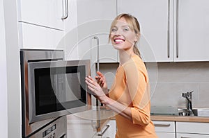 Blond woman with a microwave