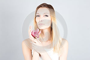 Blond woman with pink flower and permanent makeup. Beauty woman.