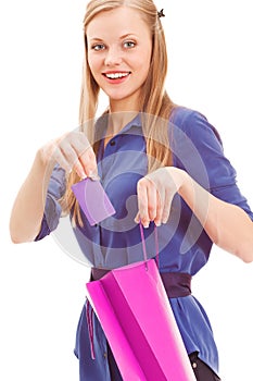 Blond woman put in card into bag