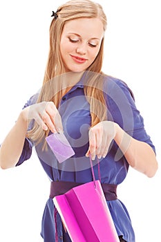 Blond woman put in card into bag