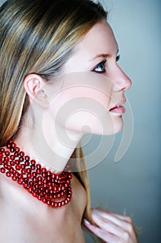 Blond woman with red beads