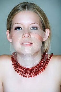Blond woman with red beads