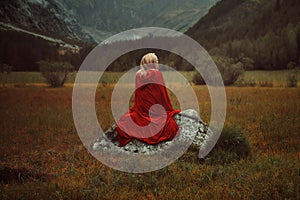 Blond woman with red cloak