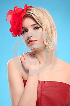 Blond woman with a red flower in hair