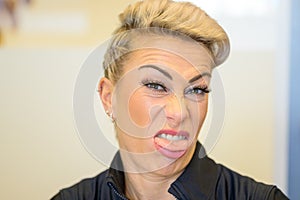 Blond woman showing her disgust and aversion photo