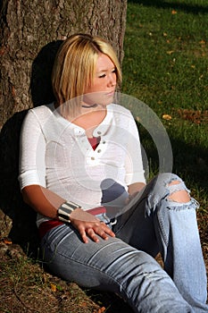 Blond Woman Sitting On Ground