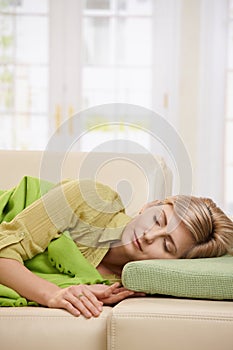 Blond woman sleeping on couch