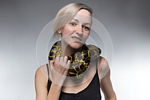 Blond woman and strangling snake