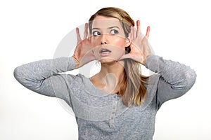 Blond woman struggling to hear