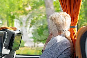 Blond woman travelling in a coach or train