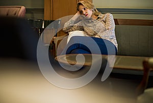 Blond woman waiting at a cafe