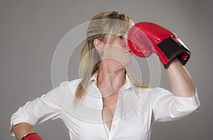 Blond woman wearing red boxing gloves