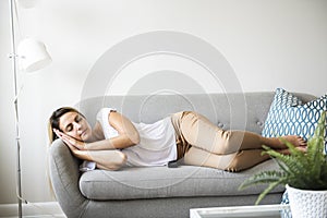 Blond women sleep on the sofa at home