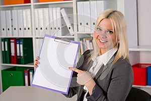 Blond young business woman with a clipboard