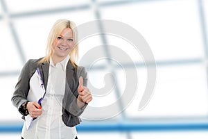 Blond young business woman with a clipboard