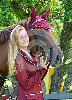 Blond young equestrian model with horse