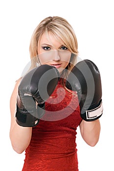 Blond young girl in boxing gloves