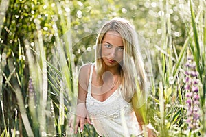 Blond young woman in a grass close-up