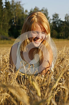 Blond young woman laughing from heart