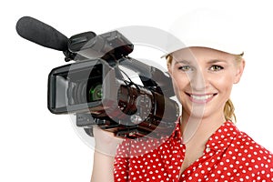 Blond young woman with professional video camcorder, on white