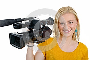 Blond young woman with professional video camcorder, on white